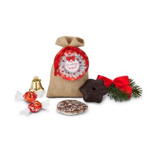 1 Oblaten-Lebkuchen (28 g, glasiert), 1 Lebkuchen-Stern (25 g, schokoliert) & 2 Lindorkugeln (je 12,5 g) verpackt im Jutesäckchen.