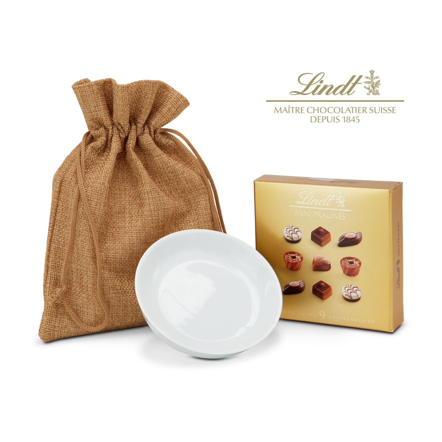 Eine edle Porzellanschale (ca. ø 10 cm) und dazu 9 kleine Lindt Mini Pralinés (44 g) verpackt in einem Jutesäckchen.